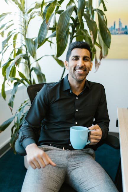 Man in Black Dress Shirt Holding Blue Ceramic Mug